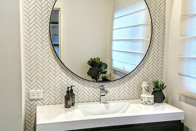 Photo of a small contemporary powder room in Other with white tile, marble, porcelain floors and grey floor.