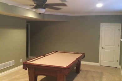 Example of a mid-sized classic underground carpeted basement design in Detroit with green walls