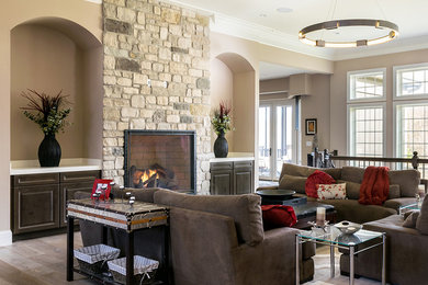 Inspiration for a timeless formal and enclosed light wood floor living room remodel in St Louis with beige walls, a standard fireplace and a stone fireplace