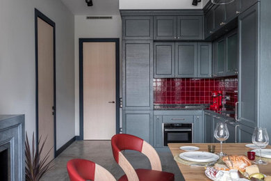 Inspiration for a medium sized modern l-shaped kitchen/diner in London with an integrated sink, shaker cabinets, grey cabinets, engineered stone countertops, red splashback, ceramic splashback, black appliances, ceramic flooring, beige floors, grey worktops and a drop ceiling.