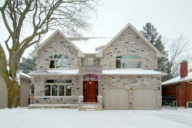 Inspiration for a large transitional two-storey beige exterior in Toronto with stone veneer.
