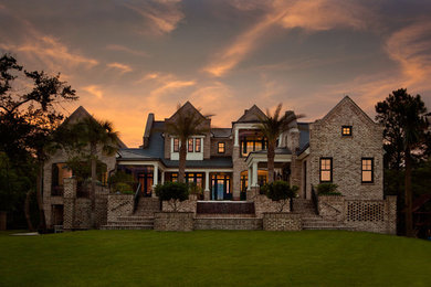 Example of a large classic two-story brick exterior home design in Charleston