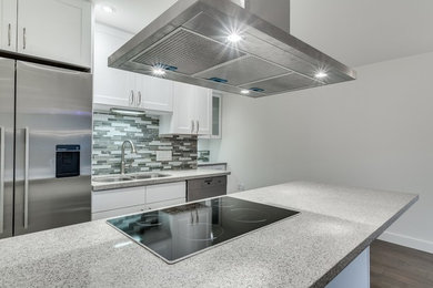 Inspiration for a large modern u-shaped medium tone wood floor open concept kitchen remodel in Vancouver with recessed-panel cabinets, white cabinets, gray backsplash, stone slab backsplash, stainless steel appliances, granite countertops, a single-bowl sink and no island