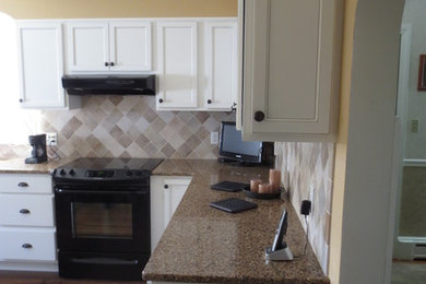 Inspiration for a mid-sized timeless l-shaped medium tone wood floor and brown floor eat-in kitchen remodel in Other with an undermount sink, shaker cabinets, white cabinets, quartz countertops, beige backsplash, ceramic backsplash, black appliances and no island