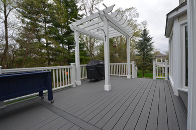 Inspiration for a small timeless backyard deck remodel with a pergola