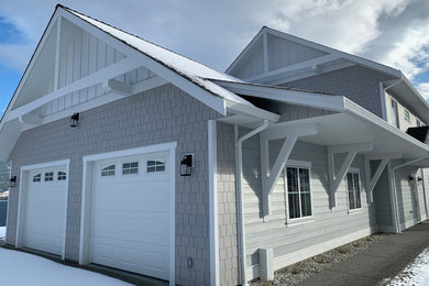 Inspiration for a large coastal mixed siding house exterior remodel in Other with a shingle roof