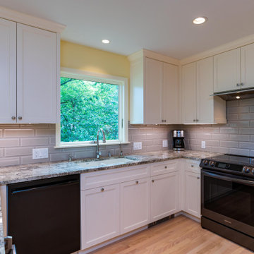Modern Kitchen With White Painted Shaker Style Cabinets With a Bevel