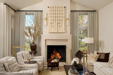 Mid-sized transitional medium tone wood floor, beige floor, vaulted ceiling and wallpaper living room photo in Denver with beige walls, a standard fireplace, a stone fireplace and no tv