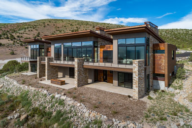 Inspiration for a large wood exterior home remodel in Salt Lake City with a metal roof