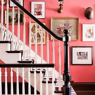 Inspiration for an expansive eclectic foyer in Chicago with pink walls, dark hardwood floors, a single front door and a dark wood front door.