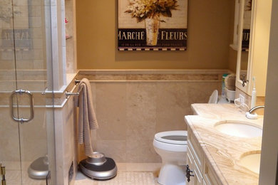 Example of a small classic master beige tile and stone tile marble floor alcove shower design in Vancouver with an undermount sink, beige cabinets, marble countertops, beige walls and recessed-panel cabinets