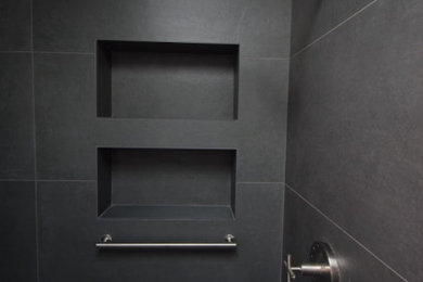 Mid-sized urban master gray tile and porcelain tile porcelain tile, gray floor and double-sink bathroom photo in DC Metro with furniture-like cabinets, brown cabinets, a bidet, beige walls, an undermount sink, quartz countertops, a hinged shower door, white countertops, a niche and a freestanding vanity