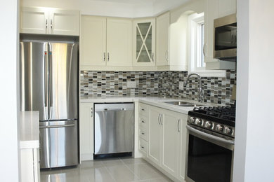 Enclosed kitchen - mid-sized contemporary l-shaped porcelain tile and gray floor enclosed kitchen idea in Toronto with a double-bowl sink, shaker cabinets, white cabinets, solid surface countertops, multicolored backsplash, mosaic tile backsplash, stainless steel appliances and no island