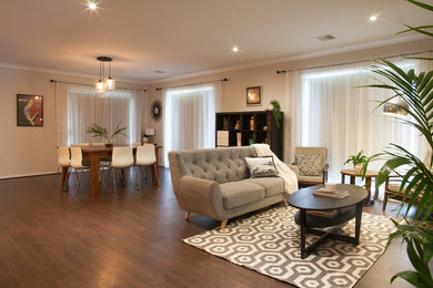 Design ideas for a transitional living room in Melbourne with laminate floors.