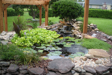 Photo of a mid-sized contemporary full sun backyard brick formal garden in Orlando for summer.