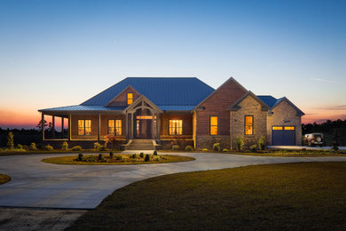 Large mountain style brown one-story wood house exterior photo in Atlanta with a hip roof and a metal roof