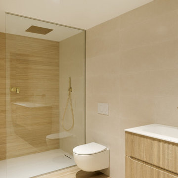 Full bathroom renovation with Brass fixtures and reeded panel vanity unit