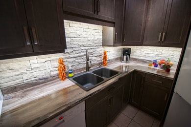 Inspiration for a timeless u-shaped ceramic tile eat-in kitchen remodel in Vancouver with dark wood cabinets, laminate countertops, white backsplash, stone slab backsplash and white appliances