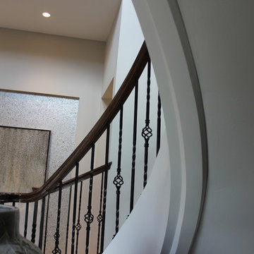 Curved Red Oak Stair with Single Basket & Twist Iron Balusters