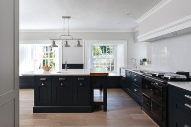 Photo of a large traditional u-shaped kitchen in Other with shaker cabinets and black cabinets.