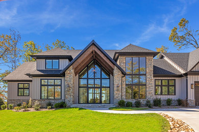 Large contemporary gray two-story mixed siding and board and batten exterior home idea in Other with a shingle roof and a gray roof