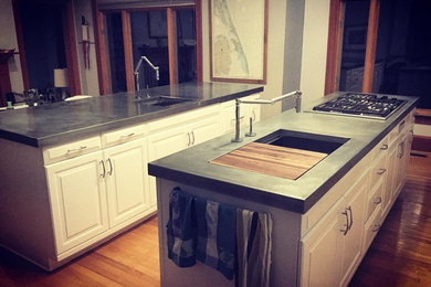 Inspiration for an industrial galley light wood floor eat-in kitchen remodel in Other with an integrated sink, stainless steel appliances and two islands