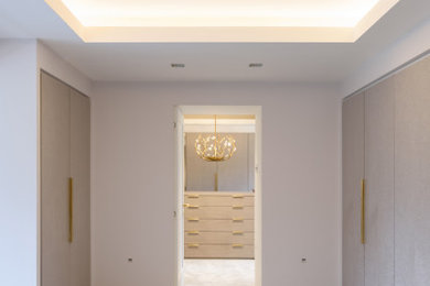 Large contemporary dressing room for women in Manchester with flat-panel cabinets, grey cabinets, carpet, grey floors and a coffered ceiling.