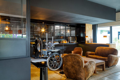Idée de décoration pour une très grande salle à manger design fermée avec un mur noir, un sol en travertin et un sol beige.
