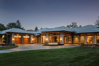 Inspiration for an expansive contemporary two-storey beige exterior in Minneapolis with stone veneer and a hip roof.