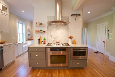 Example of a transitional galley eat-in kitchen design in Boston with a double-bowl sink, marble countertops, white backsplash, stone slab backsplash, stainless steel appliances and gray cabinets