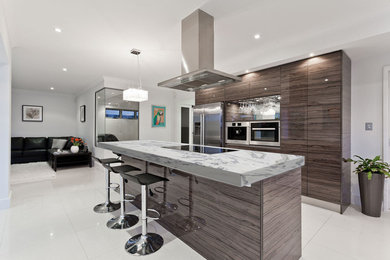 Inspiration for a contemporary galley white floor kitchen remodel in Philadelphia with flat-panel cabinets, gray cabinets and an island