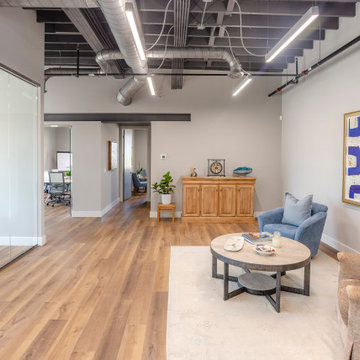 Urban Industrial Office Lounge with Exposed Ceiling and Ductwork