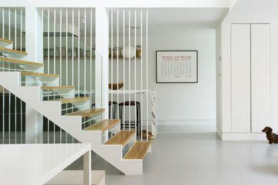 Inspiration for a contemporary wood straight staircase in London with open risers.