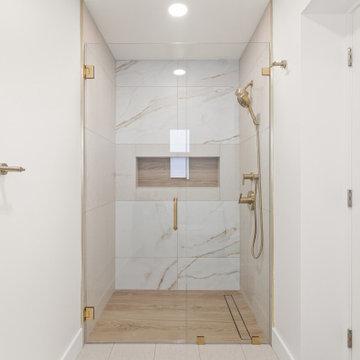 Warm Transitional Two-Room Primary Bathroom