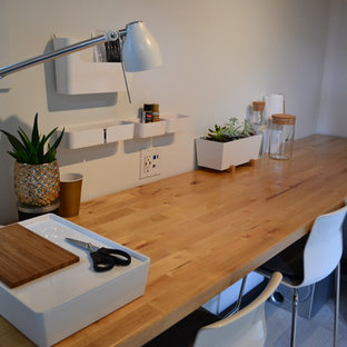 Design ideas for a small modern home studio in Seattle with white walls and a freestanding desk.