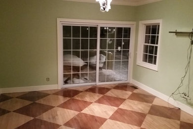 Example of a mid-sized minimalist light wood floor living room design in Grand Rapids with a tv stand