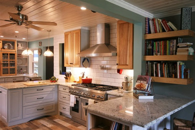 Large country u-shaped porcelain tile kitchen photo in Houston with a farmhouse sink, raised-panel cabinets, gray cabinets, granite countertops, white backsplash, subway tile backsplash, stainless steel appliances and a peninsula