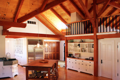 Large transitional l-shaped medium tone wood floor open concept kitchen photo in Boston with a farmhouse sink, beaded inset cabinets, white cabinets and no island