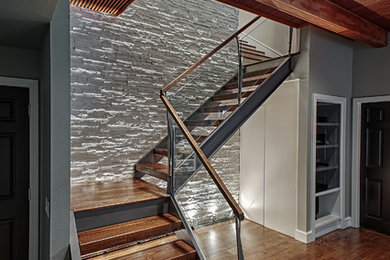 Inspiration for a large modern wooden spiral open staircase remodel in New York