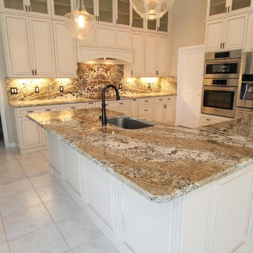 Full height back splash ivory kitchen.
