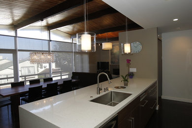Inspiration for a mid-sized contemporary l-shaped dark wood floor open concept kitchen remodel in San Francisco with an undermount sink, flat-panel cabinets, dark wood cabinets, quartz countertops, stainless steel appliances and an island