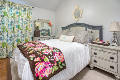 Bedroom - mid-sized farmhouse guest medium tone wood floor and brown floor bedroom idea in Oklahoma City with white walls and no fireplace