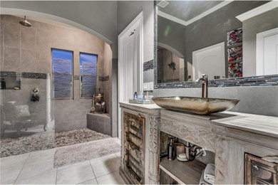 Example of an eclectic master porcelain tile and single-sink bathroom design in Austin with furniture-like cabinets, gray walls, a vessel sink, wood countertops and a freestanding vanity