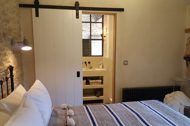 This is an example of a country bedroom in Dorset.