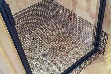 Corner shower - small traditional 3/4 beige tile and ceramic tile mosaic tile floor and multicolored floor corner shower idea in Houston with a hinged shower door