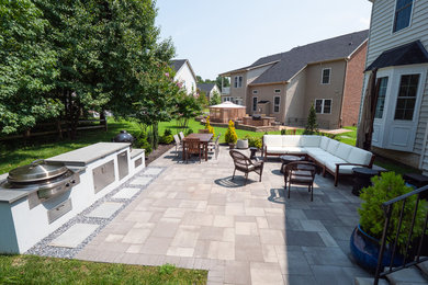 Backyard concrete paver patio kitchen photo in DC Metro