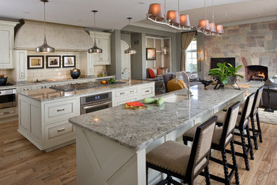 Design ideas for a traditional galley eat-in kitchen in Indianapolis with an undermount sink, beaded inset cabinets, white cabinets, granite benchtops, white splashback, ceramic splashback and stainless steel appliances.