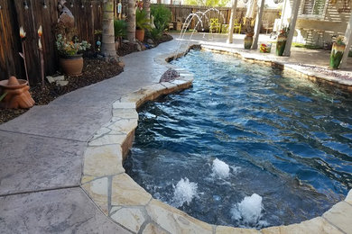 Inspiration for a small eclectic backyard stone and custom-shaped pool fountain remodel in Sacramento