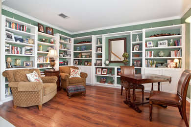 Inspiration for a mid-sized timeless freestanding desk medium tone wood floor study room remodel in Austin with green walls