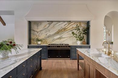 Transitional kitchen photo in San Francisco with marble countertops, marble backsplash and two islands